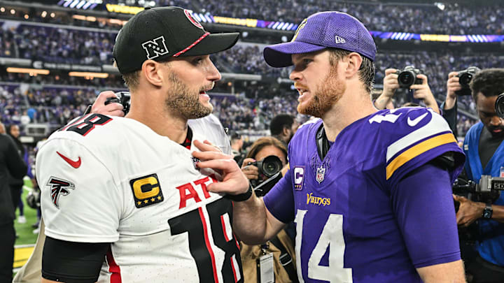 Dec 8, 2024; Minneapolis, Minnesota, USA; Atlanta Falcons quarterback Kirk Cousins (18) and Minnesota Vikings quarterback Sam Darnold (14) talk after the game at U.S. Bank Stadium.