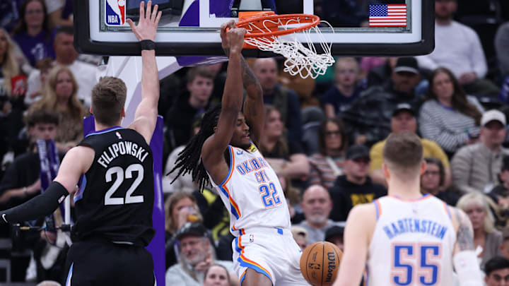 Feb 21, 2025; Salt Lake City, Utah, USA; Oklahoma City Thunder guard Cason Wallace (22) dunks against Utah Jazz forward Kyle Filipowski (22) during the fourth quarter at Delta Center. Mandatory Credit: Rob Gray-Imagn Images