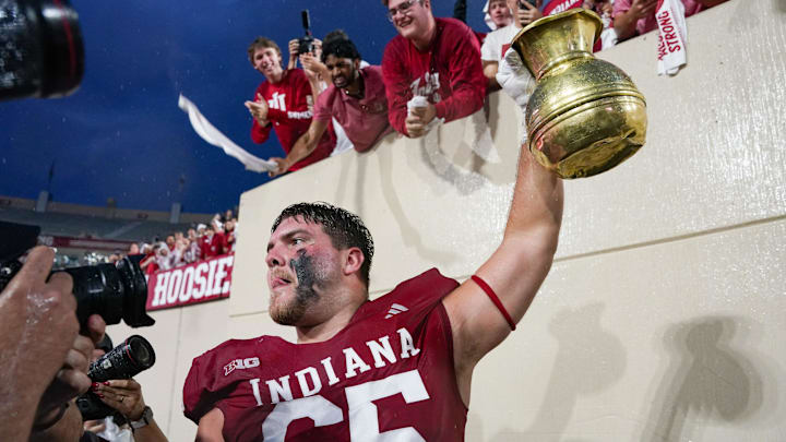 Indiana left tackle Carter Smith celebrates with the Old Brass Spittoon after the game Oct. 18, 2025, versus Michigan State.