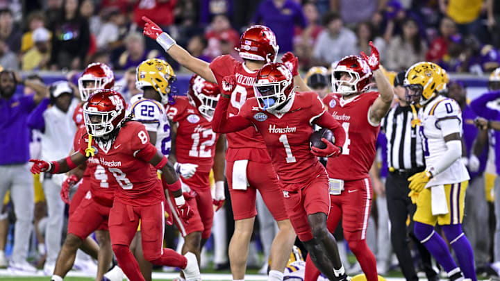 Dec 27, 2025; Houston, TX, USA; Houston Cougars defensive back Latrell McCutchin Sr. (1) recovers the onside kick during the second half against the Louisiana State Tigers at NRG Stadium. Mandatory Credit: Maria Lysaker-Imagn Images 