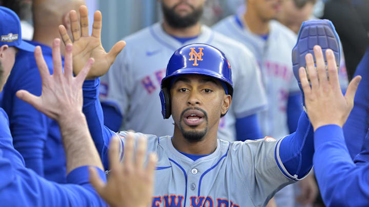 Oct 20, 2024; Los Angeles, California, USA; New York Mets shortstop Francisco Lindor (12) celebrates in the dugout after scoring in the first inning against the Los Angeles Dodgers during game six of the NLCS for the 2024 MLB playoffs at Dodger Stadium. Mandatory Credit: Jayne Kamin-Oncea-Imagn Images