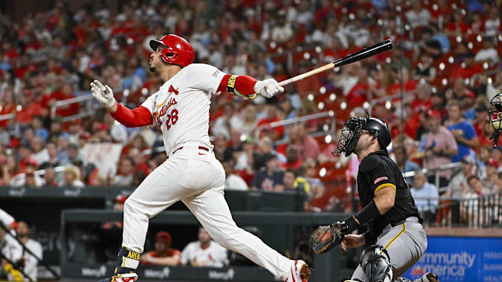 Sep 18, 2024; St. Louis, Missouri, USA;  St. Louis Cardinals third baseman Nolan Arenado (28) hits a one-run single against the Pittsburgh Pirates during the third inning at Busch Stadium.