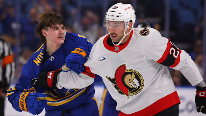 Nov 5, 2024; Buffalo, New York, USA;  Buffalo Sabres left wing Zach Benson (9) and Ottawa Senators right wing Michael Amadio (22) get into a scrum after the whistle during the third period at KeyBank Center. Mandatory Credit: Timothy T. Ludwig-Imagn Images