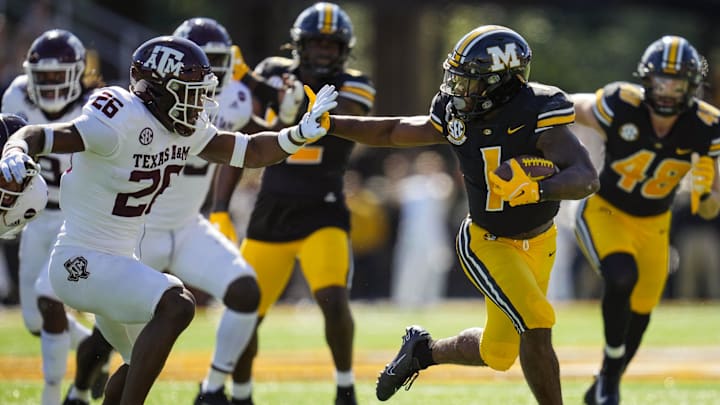 Oct 16, 2021; Columbia, Missouri, USA; Missouri Tigers running back Tyler Badie (1) runs against Texas A&M Aggies defensive back Demani Richardson (26) during the first half at Faurot Field at Memorial Stadium. Mandatory Credit: Jay Biggerstaff-Imagn Images