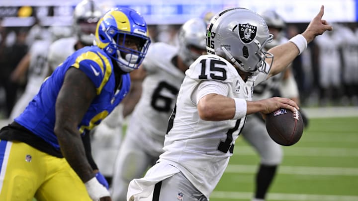Oct 20, 2024; Inglewood, California, USA; Las Vegas Raiders quarterback Gardner Minshew (15) points to throw the ball downfield with Los Angeles Rams linebacker Jared Verse (8) in pursuit in the second half at SoFi Stadium. Mandatory Credit: Alex Gallardo-Imagn Images
