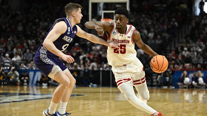 Mar 19, 2026; Portland, OR, USA; Wisconsin Badgers guard John Blackwell (25) drives against High Point Panthers guard Conrad Martinez (9) during the second half of a first round game of the men's 2026 NCAA Tournament at Moda Center. Mandatory Credit: Troy Wayrynen-Imagn Images