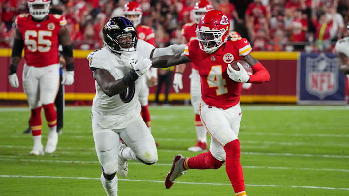Sep 5, 2024; Kansas City, Missouri, USA; Kansas City Chiefs wide receiver Rashee Rice (4) runs the ball as Baltimore Ravens linebacker Roquan Smith (0) defends during the first half at GEHA Field at Arrowhead Stadium. Mandatory Credit: Denny Medley-Imagn Images