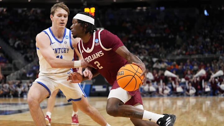 Mar 21, 2025; Milwaukee, WI, USA; Troy Trojans guard Marcus Rigsby Jr. (2) drives to the hoop past Kentucky Wildcats guard Travis Perry (11) during the first half at Fiserv Forum. Mandatory Credit: Jeff Hanisch-Imagn Images