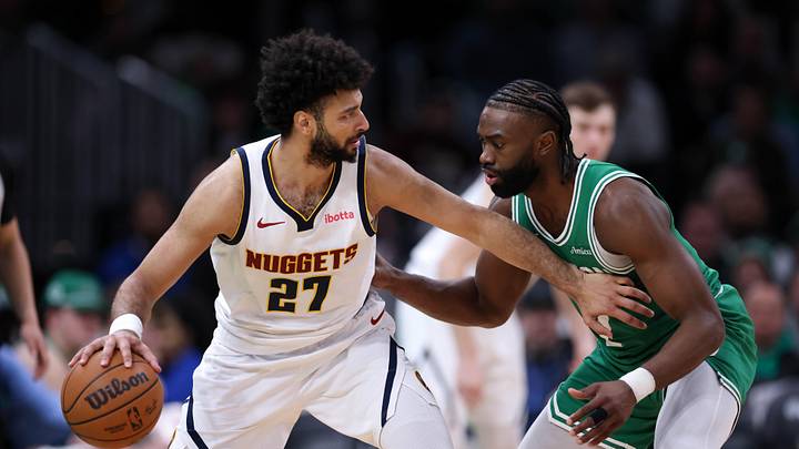 Mar 2, 2025; Boston, Massachusetts, USA; Denver Nuggets guard Jamal Murray (27) defended by Boston Celtics forward Jaylen Brown (7) during the second half at TD Garden. Mandatory Credit: Paul Rutherford-Imagn Images