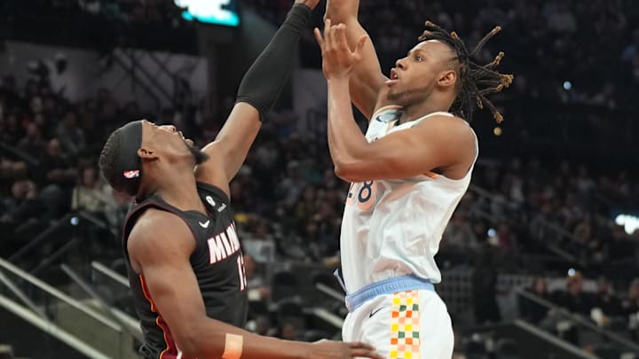 Feb 1, 2025; San Antonio, Texas, USA: San Antonio Spurs center Charles Bassey (28) shoots over Miami Heat center Bam Adebayo (13) during the first half at Frost Bank Center. Mandatory Credit: Scott Wachter-Imagn Images
