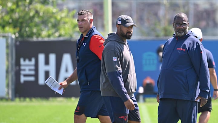 Jul 28, 2025; Foxborough, MA, USA; New England Patriots head coach Mike Vrabel (red sleeves and defensive coordinator Terrell Williams (blue pants) watch the team during training camp at Gillette Stadium. Mandatory Credit: Eric Canha-Imagn Images