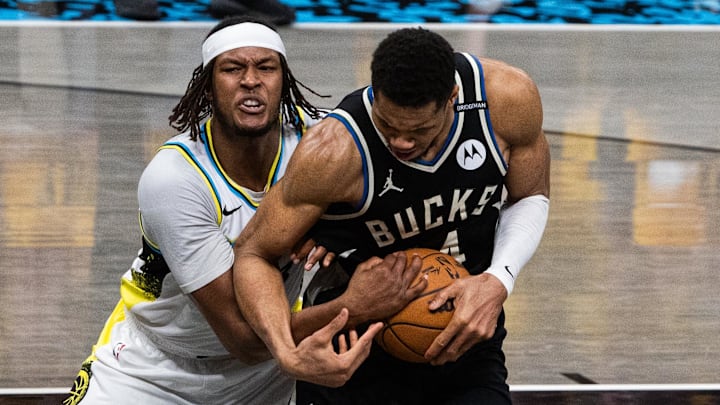 Apr 29, 2025; Indianapolis, Indiana, USA; Indiana Pacers center Myles Turner (33) and Milwaukee Bucks forward Giannis Antetokounmpo (34) fight for the ball  during game five of the first round for the 2024 NBA Playoffs at Gainbridge Fieldhouse. Mandatory Credit: Trevor Ruszkowski-Imagn Images