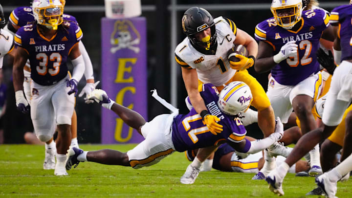 Sep 14, 2024; Greenville, North Carolina, USA;  Appalachian State Mountaineers running back Anderson Castle (1) is stopped on his run by East Carolina Pirates defensive back Ja'Marley Riddle (22) during the second half at Dowdy-Ficklen Stadium. Mandatory Credit: James Guillory-Imagn Images