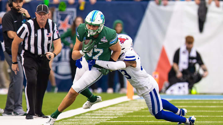 Dec 2, 2023; New Orleans, LA, USA; Tulane Green Wave tight end Alex Bauman (87) runs with the ball against Southern Methodist Mustangs safety Isaiah Nwokobia (23) during the first half at Yulman Stadium.