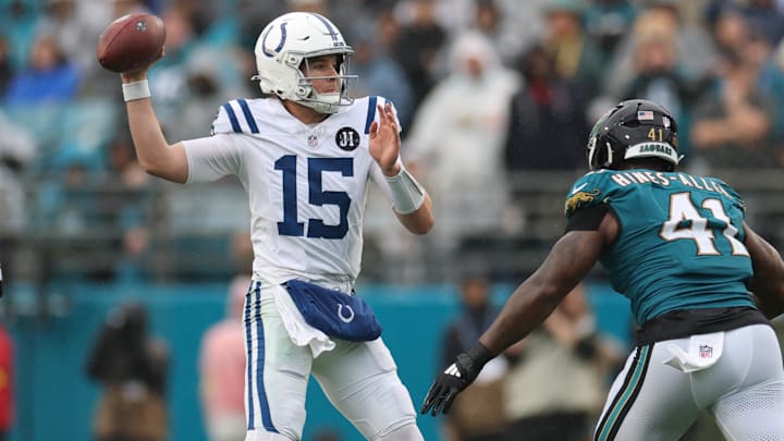 Dec 7, 2025; Jacksonville, Florida, USA; Indianapolis Colts quarterback Riley Leonard (15) looks to pass downfield Jacksonville Jaguars defensive end Josh Hines-Allen (41) defends during the first half at EverBank Stadium. Mandatory Credit: Matt Pendleton-Imagn Images