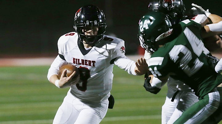 Gilbert's quarterback Ethan Rash (9) runs with the ball as Pella's linebacker/tight end Kyler VanMaanen (24) attempts to tackle during second quarter in the 4A State quarter final at Central College Football field on Friday, Nov.8, 2024, in Pella, Iowa.