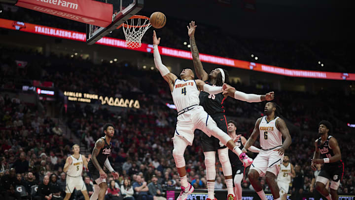 Dec 19, 2024; Portland, Oregon, USA; Denver Nuggets guard Russell Westbrook (4) drives to the basket during the second half against Portland Trail Blazers center Robert Williams III (35) at Moda Center. Mandatory Credit: Troy Wayrynen-Imagn Images Dec 19, 2024; Portland, Oregon, USA; Denver Nuggets guard Russell Westbrook (4) drives to the basket during the second half against Portland Trail Blazers center Robert Williams III (35) at Moda Center. Mandatory Credit: Troy Wayrynen-Imagn Images