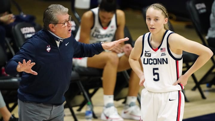Mar 1, 2021; Storrs, Connecticut, USA; UConn Huskies head coach Geno Auriemma talks with guard Paige Bueckers (5) during a break in the first quarter against the Marquette Golden Eagles at Harry A. Gampel Pavilion. Mandatory Credit: David Butler II-Imagn Images Mar 1, 2021; Storrs, Connecticut, USA; UConn Huskies head coach Geno Auriemma talks with guard Paige Bueckers (5) during a break in the first quarter against the Marquette Golden Eagles at Harry A. Gampel Pavilion. Mandatory Credit: David Butler II-Imagn Images