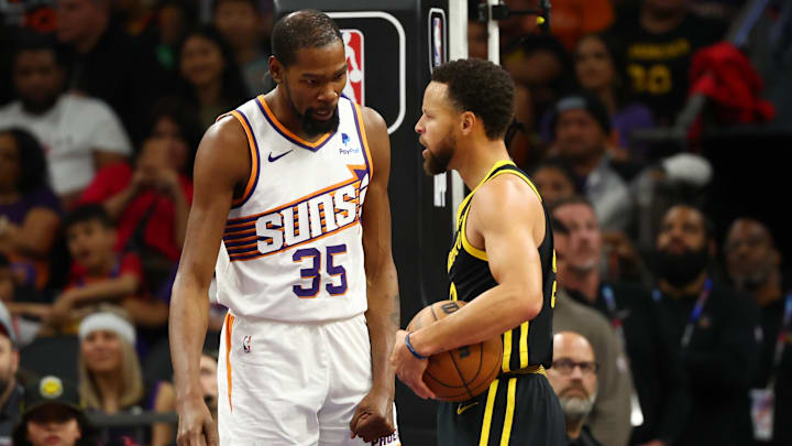 Nov 22, 2023; Phoenix, Arizona, USA; Phoenix Suns forward Kevin Durant (35) talks to Golden State Warriors guard Stephen Curry after a foul in the first half at Footprint Center. Mandatory Credit: Mark J. Rebilas-Imagn Images