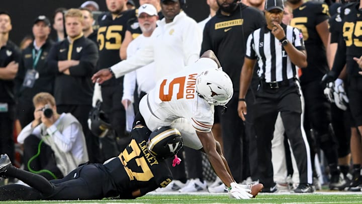 Oct 26, 2024; Nashville, Tennessee, USA;  Vanderbilt Commodores cornerback Jaylin Lackey (27) tackles Texas Longhorns wide receiver Ryan Wingo (5) during the first half at FirstBank Stadium. Mandatory Credit: Steve Roberts-Imagn Images