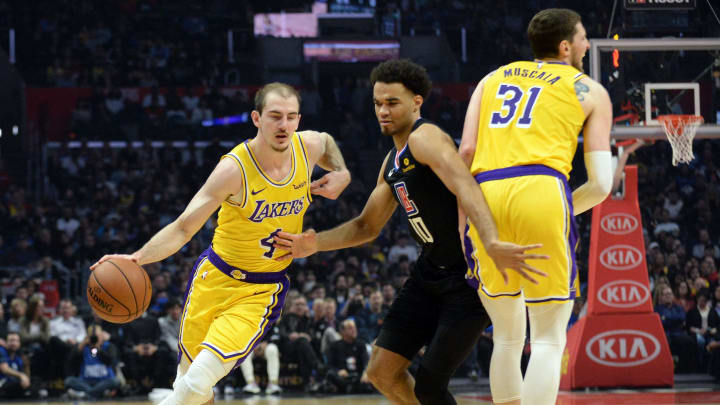April 5, 2019; Los Angeles, CA, USA; Los Angeles Lakers guard Alex Caruso (4) moves the ball as forward Mike Muscala (31) screens against Los Angeles Clippers guard Jerome Robinson (10) during the first half at Staples Center. Mandatory Credit: Gary A. Vasquez-USA TODAY Sports