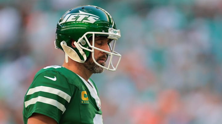 Dec 8, 2024; Miami Gardens, Florida, USA; New York Jets quarterback Aaron Rodgers (8) reacts on the field against the Miami Dolphins during the fourth quarter at Hard Rock Stadium. Mandatory Credit: Sam Navarro-Imagn Images