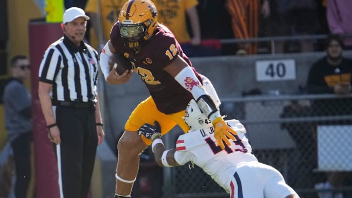 Arizona State tight end Jalin Conyers (12) is brought down by Arizona safety Dalton Johnson (43) during the second quarter at Mountain America Stadium in Tempe on Nov. 25, 2023.