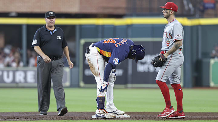 Sep 22, 2024; Houston, Texas, USA; Houston Astros left fielder Yordan Alvarez (44) holds his leg after hitting a double as Los Angeles Angels shortstop Zach Neto (9) looks on during the third inning at Minute Maid Park. 