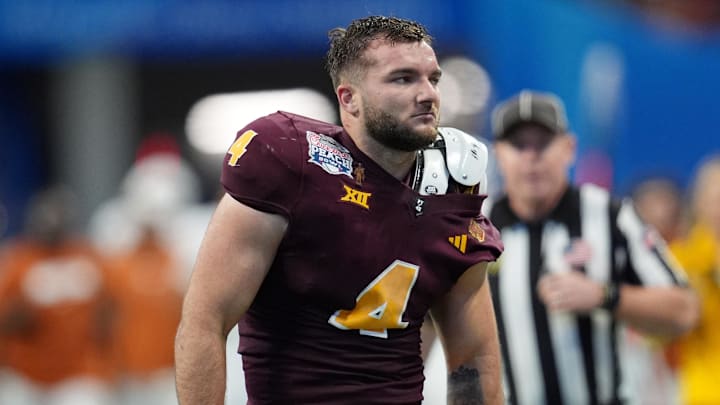 Jan 1, 2025; Atlanta, GA, USA; Arizona State Sun Devils running back Cam Skattebo (4) reacts after losing his helmet while being tackled by Texas Longhorns defensive back Michael Taaffe (16) during the second half of the Peach Bowl at Mercedes-Benz Stadium.