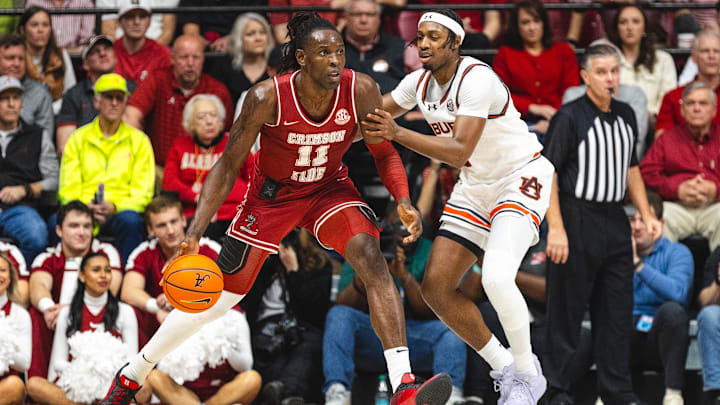 Feb 15, 2025; Tuscaloosa, Alabama, USA; Alabama Crimson Tide center Clifford Omoruyi (11) controls the ball as Auburn Tigers guard Denver Jones (2) defends during the first half at Coleman Coliseum. Mandatory Credit: Will McLelland-Imagn Images