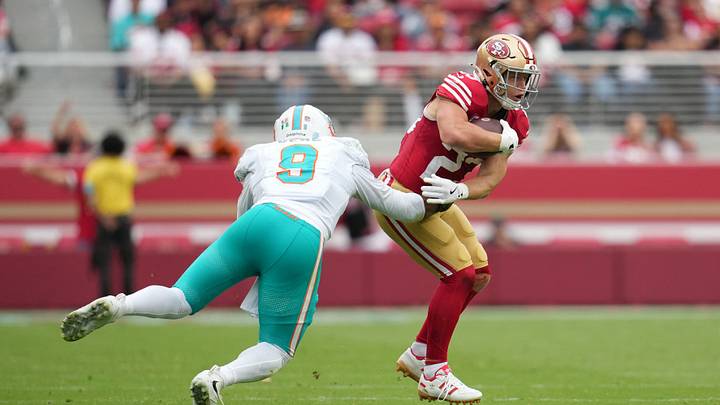 San Francisco 49ers running back Christian McCaffrey (23) runs against Miami Dolphins defensive end Josh Uche (9) in the second half at Levi's Stadium. San Francisco 49ers running back Christian McCaffrey (23) runs against Miami Dolphins defensive end Josh Uche (9) in the second half at Levi's Stadium.