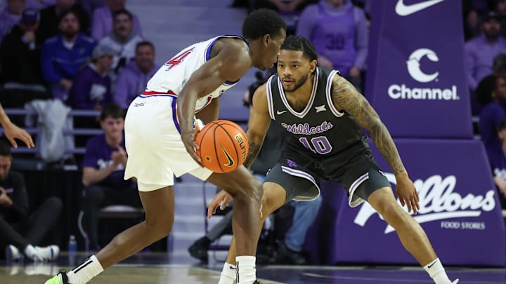 Jan 24, 2026; Manhattan, Kansas, USA; Kansas Jayhawks guard Melvin Council Jr. (14) is guarded by Kansas State Wildcats guard David Castillo (10) during the first half at Bramlage Coliseum. Mandatory Credit: Scott Sewell-Imagn Images