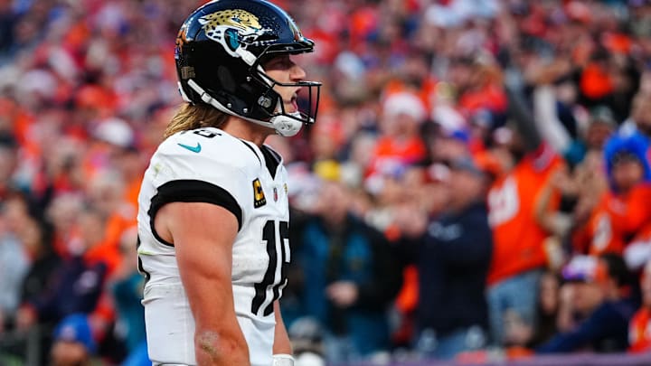 Dec 21, 2025; Denver, Colorado, USA; Jacksonville Jaguars quarterback Trevor Lawrence (16) reacts after rushing for a touchdown against the Denver Broncos during the second half at Empower Field at Mile High. Mandatory Credit: Ron Chenoy-Imagn Images