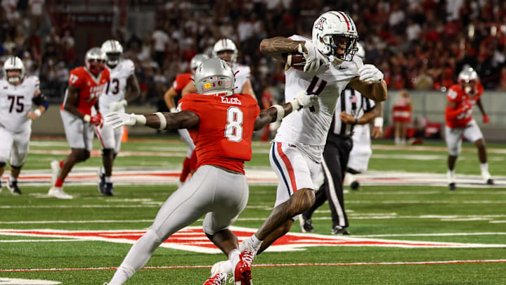 Aug 31, 2024; Tucson, Arizona, USA; Arizona Wildcats wide receiver Tetairoa McMillan (4) dodges tackle from New Mexico Lobos safety Christian Ellis (8) during third quarter at Arizona Stadium.