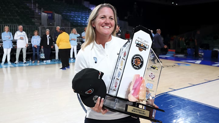 Nov 25, 2024; Paradise Island, Bahamas, BHS; North Carolina Tar Heels head coach Courtney Banghart celebrates with the Battle4Atlantis trophy after the game against the Indiana Hoosiers at the Atlantis Resort. Mandatory Credit: Kevin Jairaj-Imagn Images