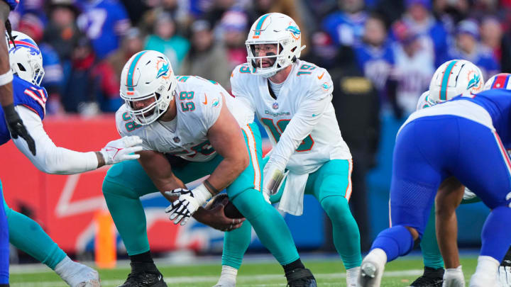 Jan 15, 2023; Orchard Park, New York, USA; Miami Dolphins guard Connor Williams (58) snaps the ball to Miami Dolphins quarterback Skylar Thompson (19) during a wild card game against the Buffalo Bills at Highmark Stadium. Mandatory Credit: Gregory Fisher-USA TODAY Sports