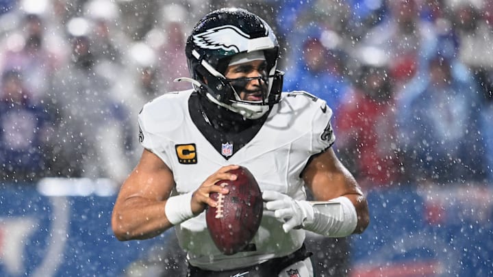 Dec 28, 2025; Orchard Park, New York, USA; Philadelphia Eagles quarterback Jalen Hurts (1) looks to throw a pass in heavy rain against the Buffalo Bills during the second quarter at Highmark Stadium. Mandatory Credit: Mark Konezny-Imagn Images