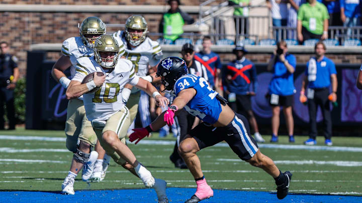 Oct 18, 2025; Durham, North Carolina, USA; Georgia Tech Yellow Jackets quarterback Haynes King (10) runs with the ball and is defended by Duke Blue Devils linebacker Luke Mergott (34) during the first half of the game at Wallace Wade Stadium. Mandatory Credit: Jaylynn Nash-Imagn Images