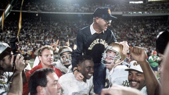 Jan 1, 1990; Miami, FL, USA; FILE PHOTO; Notre Dame Irish head coach Lou Holtz is carried off the field following their victory over Colorado winning the 1989 National Championship at the Orange Bowl. Mandatory Credit: Photo By Imagn Images © Copyright  Imagn Images