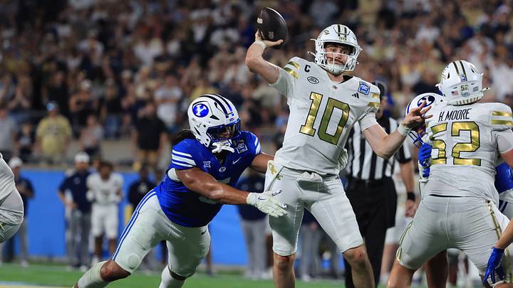 Dec 27, 2025; Orlando, FL, USA; Georgia Tech Yellow Jackets quarterback Haynes King (10) throws the ball as BYU Cougars linebacker Nusi Taumoepeau (5) pressures during the second half at Camping World Stadium. Mandatory Credit: Kim Klement Neitzel-Imagn Images