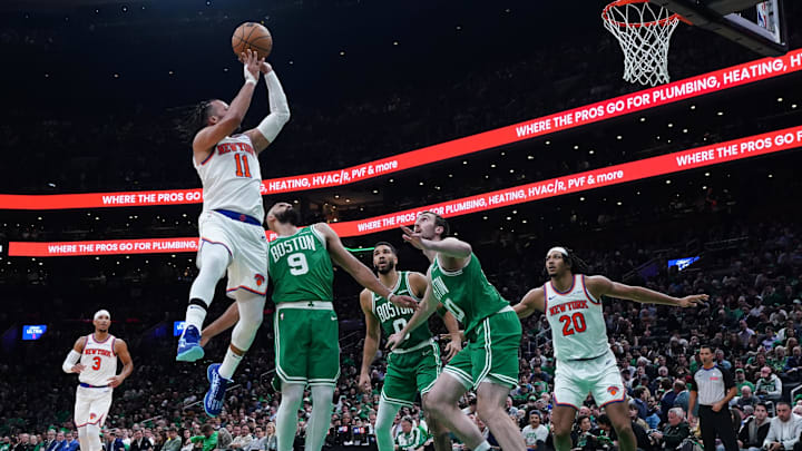 Oct 22, 2024; Boston, Massachusetts, USA; New York Knicks guard Jalen Brunson (11) shoots against Boston Celtics guard Derrick White (9) in the second half at TD Garden. Mandatory Credit: David Butler II-Imagn Images