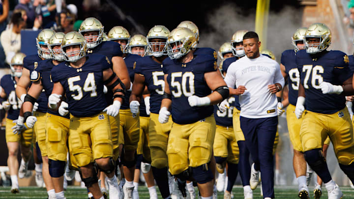 Notre Dame head coach Marcus Freeman runs out with his team before a NCAA college football game between Notre Dame and Stanford at Notre Dame Stadium on Saturday, Oct. 12, 2024, in South Bend. Notre Dame head coach Marcus Freeman runs out with his team before a NCAA college football game between Notre Dame and Stanford at Notre Dame Stadium on Saturday, Oct. 12, 2024, in South Bend.
