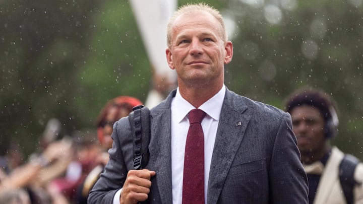 Aug 31, 2024; Tuscaloosa, Alabama, USA;  Fans watch as Alabama Crimson Tide head coach Kalen DeBoer walks down the Walk of Champions with his team outside of Bryant-Denny Stadium. Mandatory Credit: Will McLelland-Imagn Images