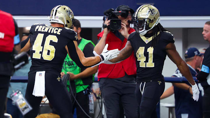 Sep 15, 2024; Arlington, Texas, USA; New Orleans Saints running back Alvin Kamara (41) celebrates with New Orleans Saints fullback Adam Prentice (46) after scoring a touchdown  during the second half against the Dallas Cowboys at AT&T Stadium. Mandatory Credit: Kevin Jairaj-Imagn Images