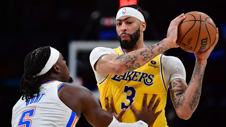 Mar 4, 2024; Los Angeles, California, USA; Los Angeles Lakers forward Anthony Davis (3) controls the ball against Oklahoma City Thunder guard Luguentz Dort (5) during the first half at Crypto.com Arena. Mandatory Credit: Gary A. Vasquez-Imagn Images