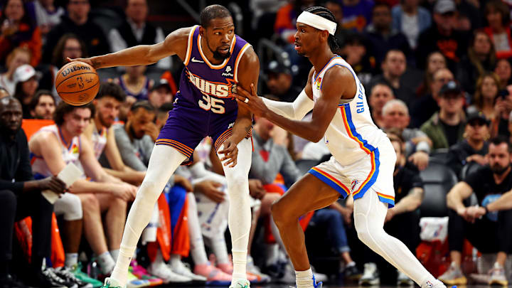 Mar 3, 2024; Phoenix, Arizona, USA; Phoenix Suns forward Kevin Durant (35) handles the ball against Oklahoma City Thunder guard Shai Gilgeous-Alexander (2) during the second quarter at Footprint Center. Mandatory Credit: Mark J. Rebilas-Imagn Images