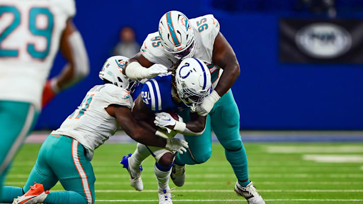 Indianapolis Colts running back Trey Sermon (27) is tackled by Miami Dolphins defensive tackle Benito Jones (95) and linebacker David Long Jr. (11) during the second half at Lucas Oil Stadium. Indianapolis Colts running back Trey Sermon (27) is tackled by Miami Dolphins defensive tackle Benito Jones (95) and linebacker David Long Jr. (11) during the second half at Lucas Oil Stadium.