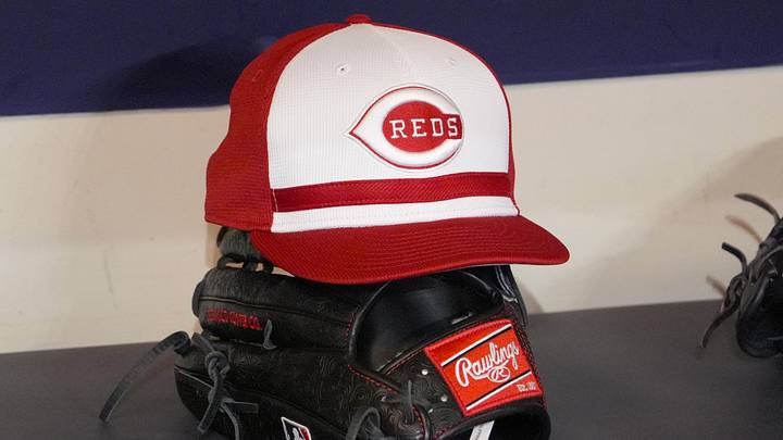 Apr 4, 2025; Milwaukee, Wisconsin, USA; Cincinnati Reds hat and glove rest on the bench in the dugout before a game against the Milwaukee Brewers at American Family Field. Mandatory Credit: Michael McLoone-Imagn Images Apr 4, 2025; Milwaukee, Wisconsin, USA; Cincinnati Reds hat and glove rest on the bench in the dugout before a game against the Milwaukee Brewers at American Family Field. Mandatory Credit: Michael McLoone-Imagn Images