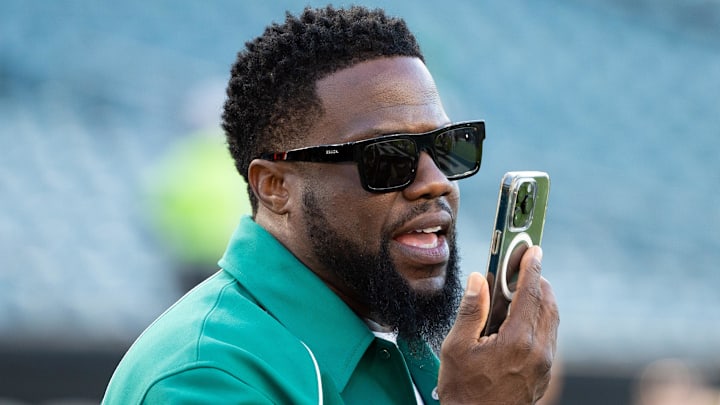 Sep 14, 2023; Philadelphia, Pennsylvania, USA; Actor Kevin Hart talks on the phone during warm ups between the Philadelphia Eagles and the Minnesota Vikings at Lincoln Financial Field / Bill Streicher-Imagn Images