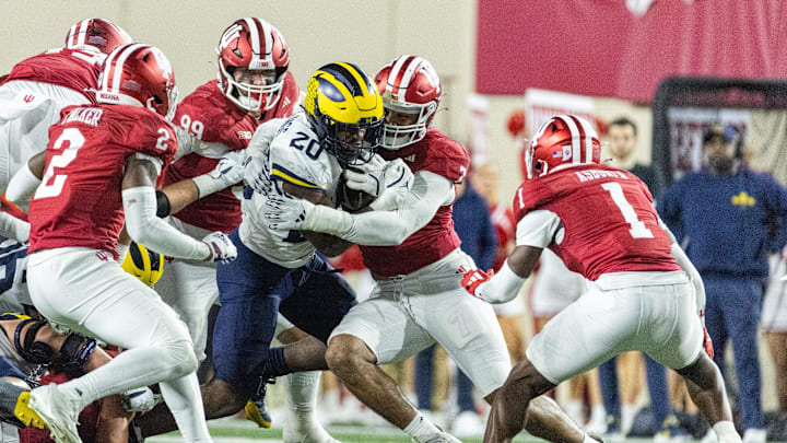 Michigan Wolverines running back Kalel Mullings (20) runs with the ball while Indiana Hoosiers linebacker Jailin Walker (2) and defensive lineman Jacob Mangum-Farrar (7) defend in the second half at Memorial Stadium.